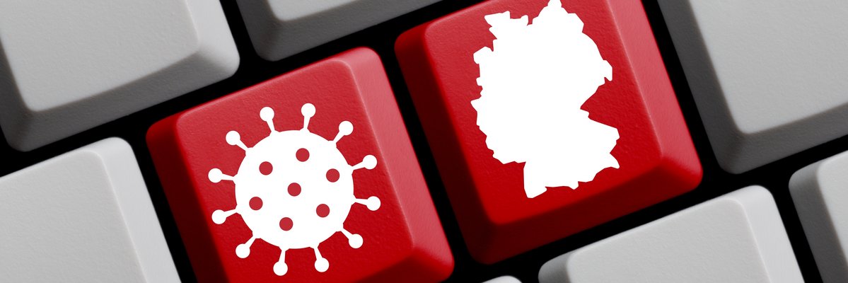 zwei rote Computertasten mit dem Symbol eines Virus und der Deutschlandkarte